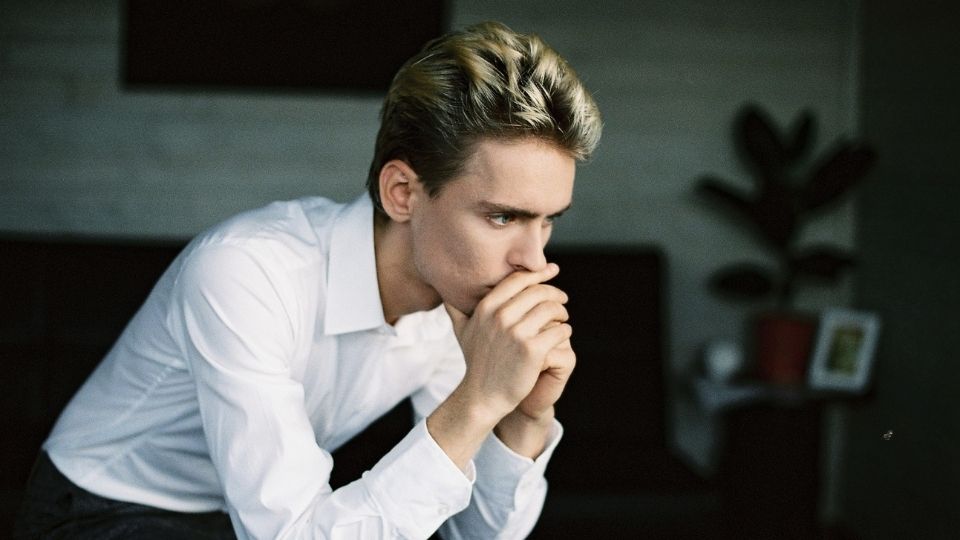 a man nervously thinks about the signs of his drug addiction.