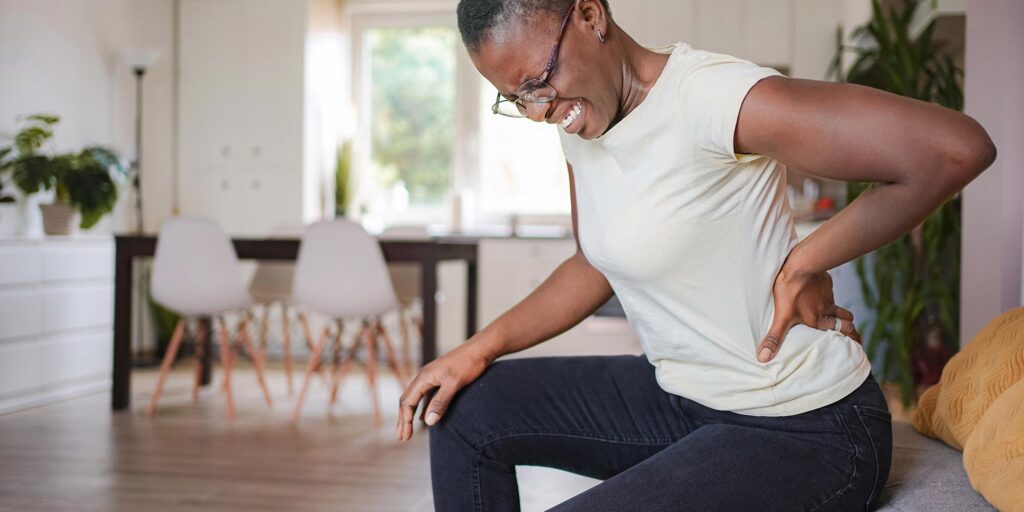 Is Methocarbamol Addictive? A woman holding her back from pain.